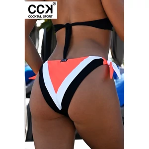 Kép 1/3 - Fekete-fehér-neon korall (rio), oldalt megkötős, hagyományos fazonú tricolor bikini alsó.